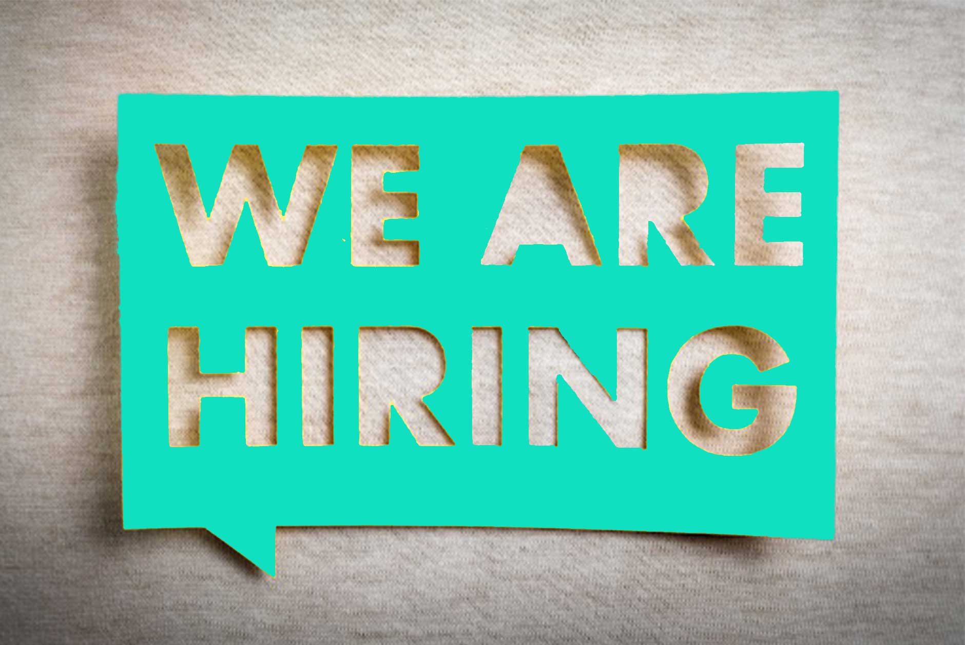We are hiring sign on beige background