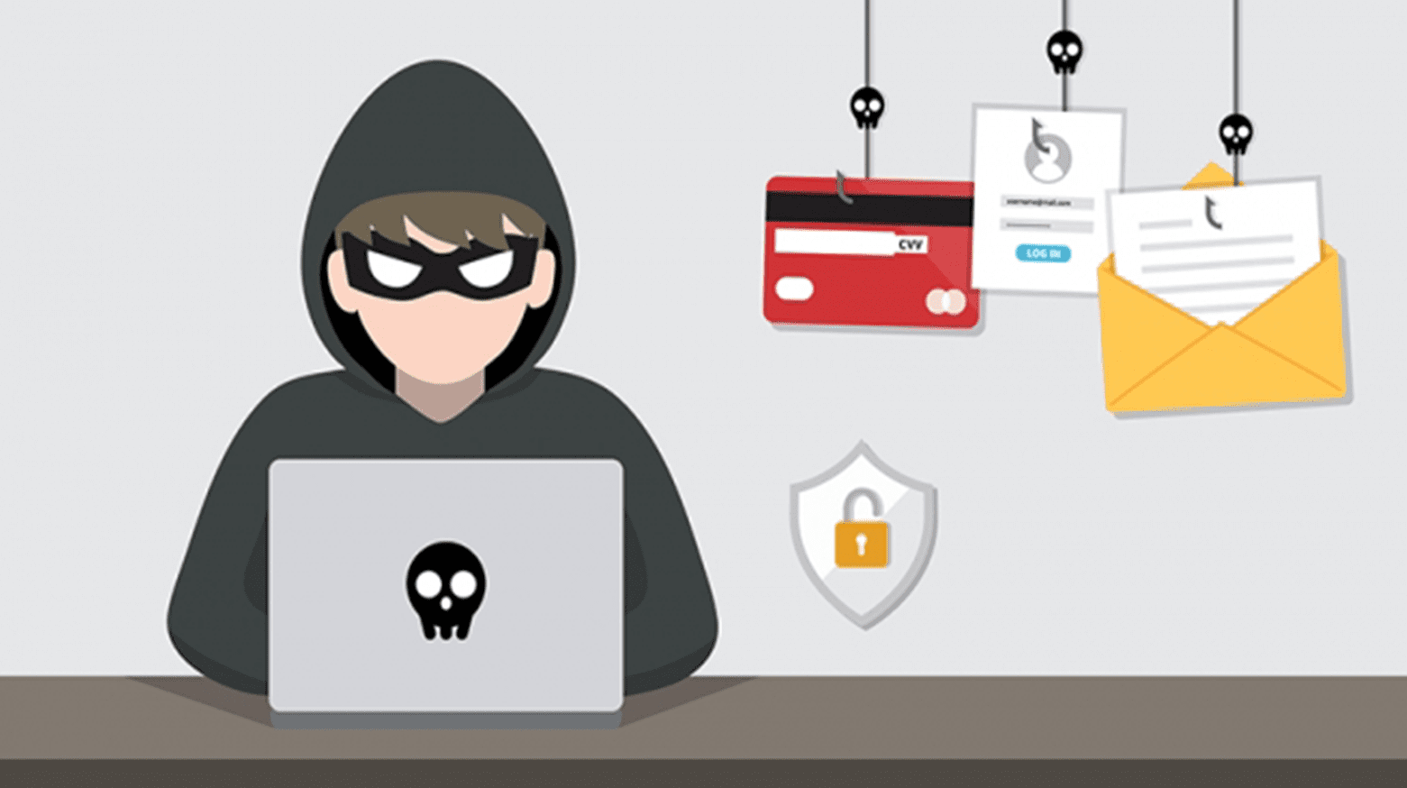 Person in hoodie working on laptop at desk